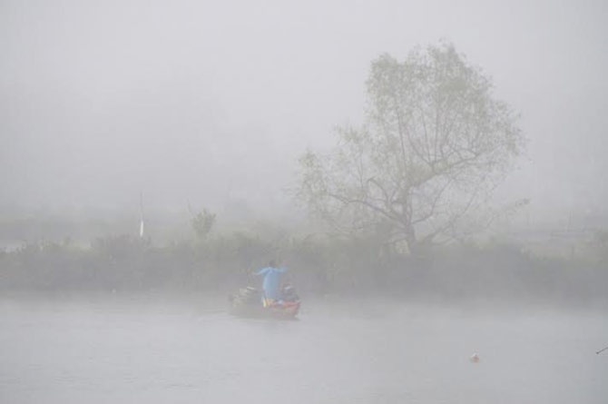 Suong mu day dac, ngu dan mac ao mua di cau hinh anh