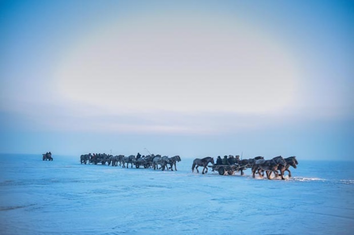 Những ngư dân làm việc bên cạnh các hố băng đào trên mặt hồ.