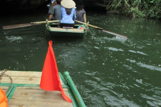 Những bóng lưng xanh xanh của người lái đò nơi này và chiếc cờ hiệu màu đỏ Việt Nam dường như đã trở thành một biểu tượng không thể thiếu ở Tràng An.
