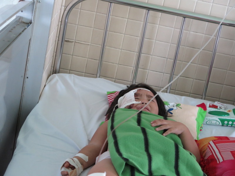 Bé Thùy Vân đau đớn do bị kính cứa vào mặt sau tiếng nổ sập nhà.