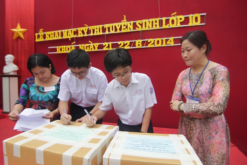 Hai học sinh kiểm tra tình trạng đề thi.