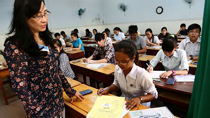 Giám thị cho thí sinh kiểm tra niêm phong túi đề thi môn toán năm 2014 tại một hội đồng thi ở TP.HCM.