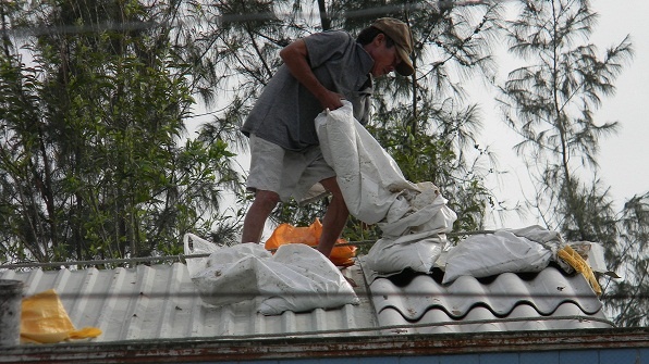 Nguoi gia, tre em treo len noc nha chong sieu bao hinh anh