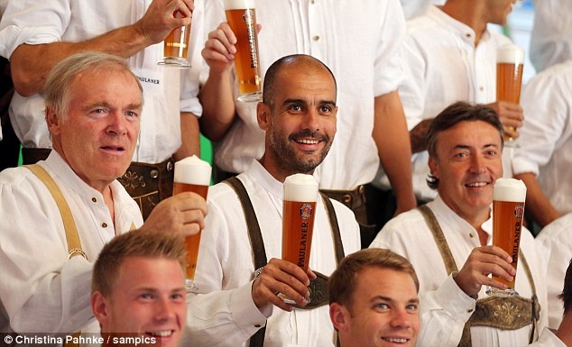 Raise a glass: Guardiola and his coaching team will be hoping for similar success this season