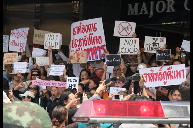 Trước đó, sáng 24-5, nhóm này đã tụ tập trước tổ hợp chiếu bóng Major Ratchayothin ở Bangkok, cầm các tấm biển nhỏ với các biểu ngữ phản đối đảo chính và tướng Prayuth Chan-ocha, lãnh đạo cuộc đảo chính hôm 22/5. Ảnh: Bangkok Post.