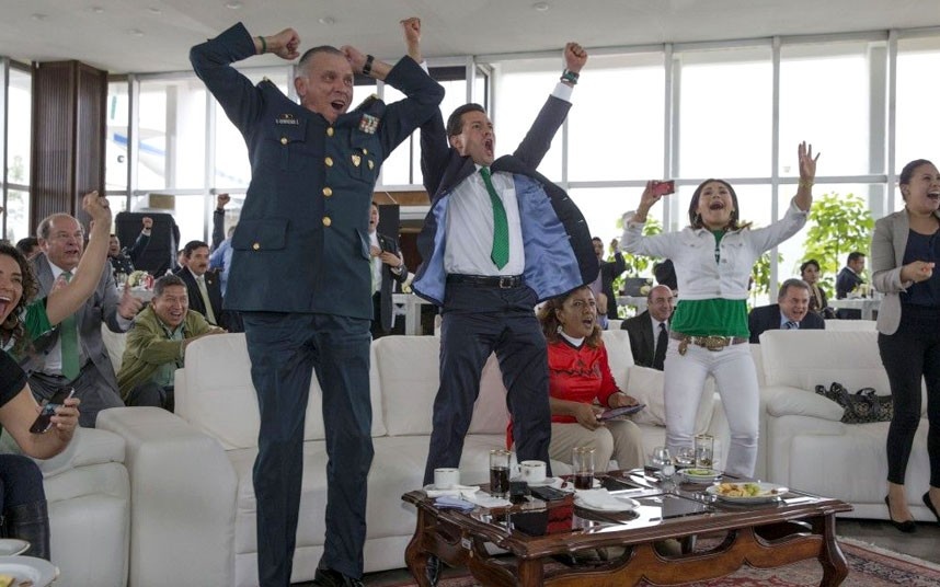 Mexican President Enrique Pena Nieto, right, and Defense Secretary Salvador Zepeda celebrate a goal during the Mexico v Croatia World Cup match. Mexico won 3-1 and qualified to the knock-out phase. Picture: Gustavo Comacho/Rex Features