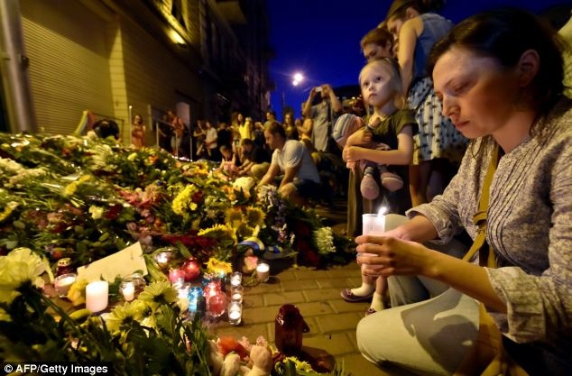 Mọi người đặt hoa và thắp nến tưởng niệm các nạn nhân vụ MH17 bên ngoài Đại sứ quán Hà Lan ở Kiev. Hơn một nửa hành khách thiệt mạng là người Hà Lan. Ảnh: AFP