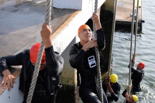 Học viên Jared Lim, 21 tuổi, đang leo lên tháp bằng một sợi dây thừng. 