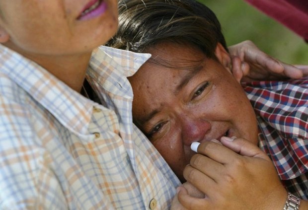 Một phụ nữ than khóc sau khi khẳng định được chồng bà đã chết trong trận sóng thần. Bà cũng đã tìm thấy thi thể của chồng trong nhà xác. Ảnh: AFP