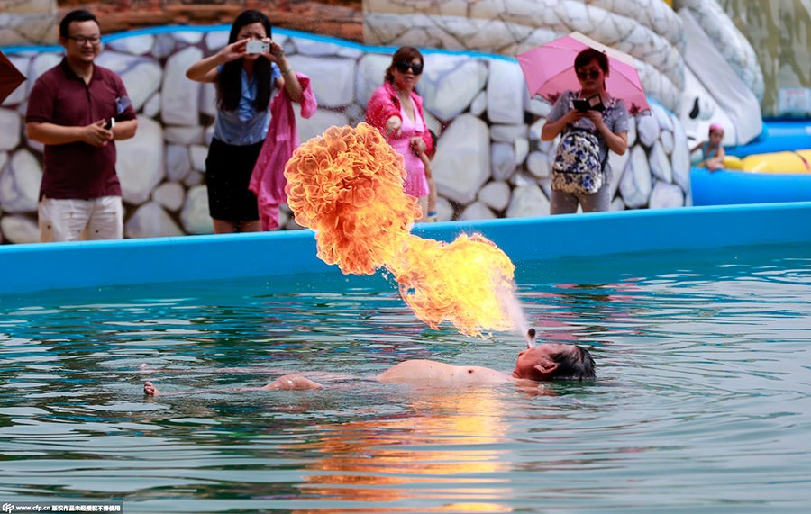 Ông Su ChuanDong, 72 tuổi, khoe kỹ năng “phun” lửa trong bể bơi của một công viên nước tại thành phố Vũ Hán, tỉnh Hồ Bắc, Trung Quốc. Ảnh: CFP