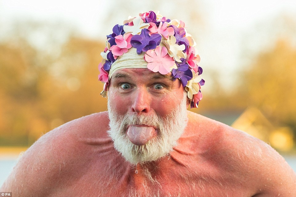 A member of the Serpentine Swimming Club poses for the camera after taking part in the Peter Pan Cup race, held every Christmas Day