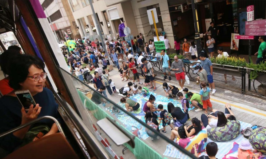 Dan Hong Kong trai tham giua duong doc sach nho lenh cam xe hinh anh