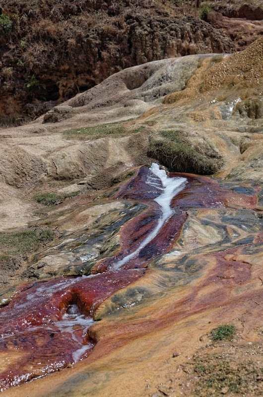 Hơn nữa, nguồn nước ấm này đi qua đường ống sắt và sắt cũng được axit cacbonic hòa tan. Nước giàu hàm lượng điôxít carbon đẩy vào đường ống bị nén lại và khi nước xuất hiện ở cuối đường ống, áp suất giảm đột ngột khiến khí điôxít carbon hòa tan và phun ra trong quá trình tạo ra bong bóng thực chất đúng với hiện tượng mạch một mạch nước phun. Điều này cũng tương tự như mở bung nắp một chai sođa.