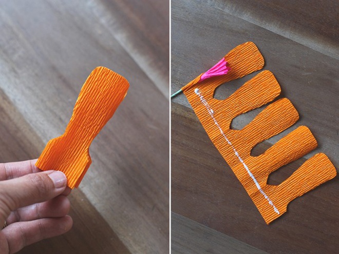 Tạo hoa pansy bằng cách gấp và cắt tờ giấy xếp màu cam rồi dán keo như hình minh họa.