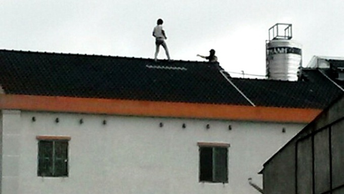 Trộm xe đạp cố thủ trên nóc nhà.