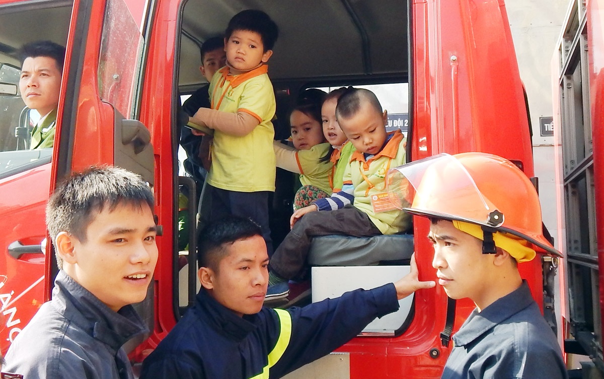 Trẻ được lần lượt trèo lên xe chữa cháy để cảm nhận và trải nghiệm thực tế. 