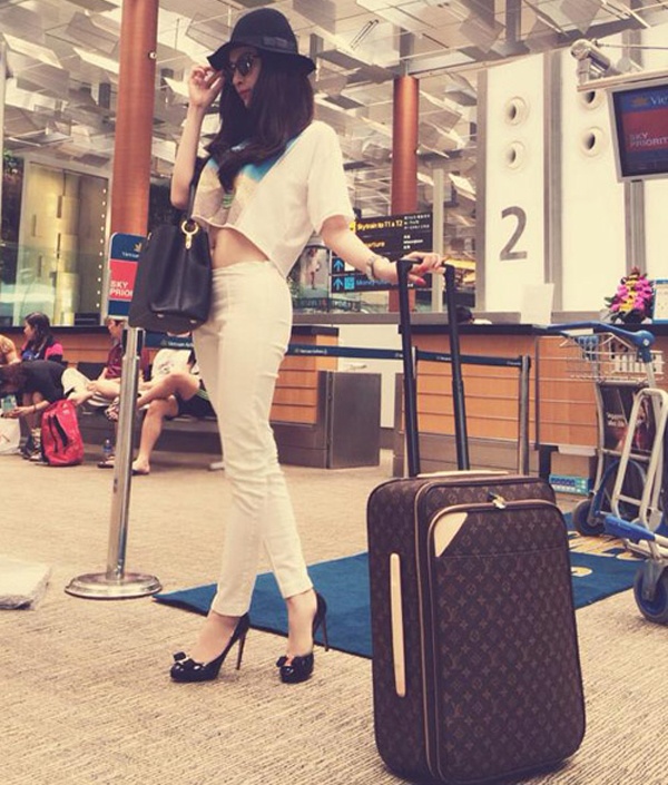 Ngôi sao trẻ khoe vòng 2 thon với crop top trắng, phụ kiện tông màu đen ở sân bay.