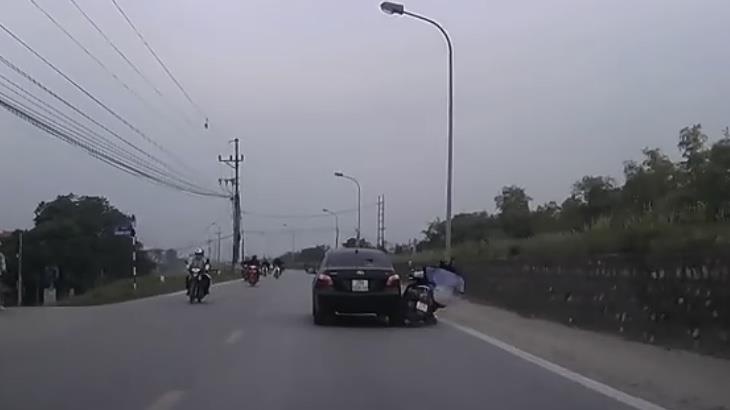 Vap vat can, nguoi lai xe may suyt bi cuon vao gam oto hinh anh