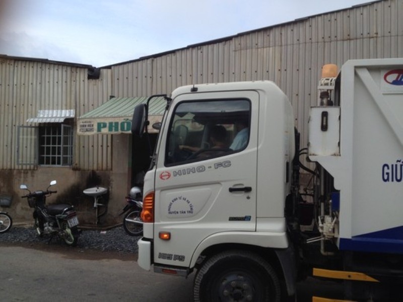 Cháu bé 5 tuổi ngồi ở vị trị lái chính, sau lưng là ông nội cũng là tài xế xe rác