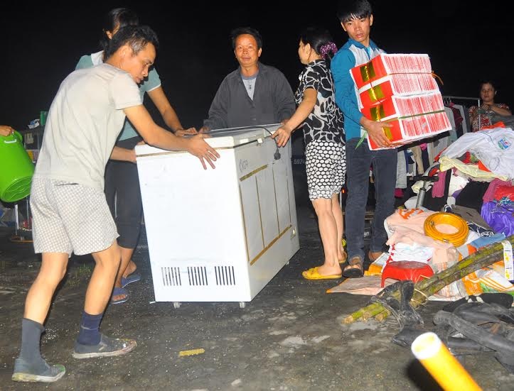 Người dân di chuyển đồ đạc khỏi hiện trường.