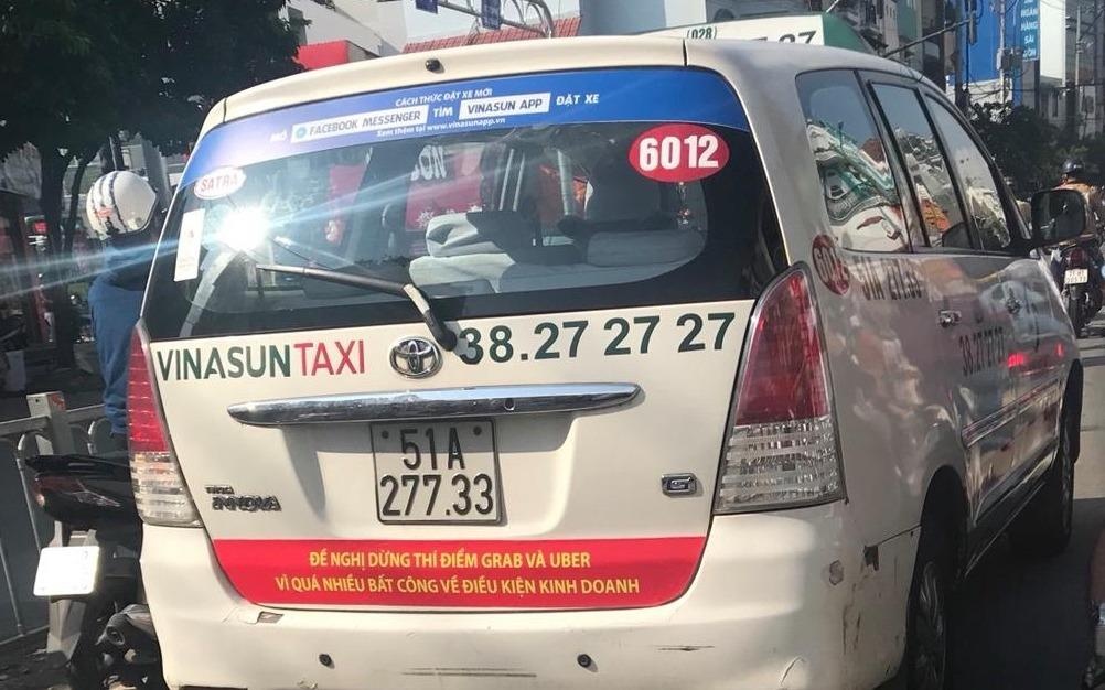 Taxi dan khau hieu phan doi Grab, Uber da vi pham Luat Canh tranh? hinh anh