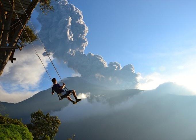 Nơi tận cùng thế giới ở Banos, Ecuador chụp lại cảnh một người đàn ông ngồi trên xích đu nhìn về ngọn núi lửa Tungurahua đang phun trào. Sau vài phút chụp tấm ảnh này, tác giả đã phải sơ tán do một đám mây bụi tràn đến. Tác giả: Sean Hacker Teper - Ảnh: National Geographic