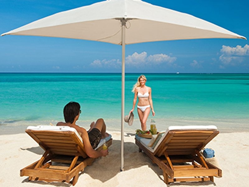 Những vị khách tại Sandals Carlyle Inn (Jamaica) có thể thư giãn trên ghế salon nằm ngắm biển với bờ cát trắng tuyệt đẹp.