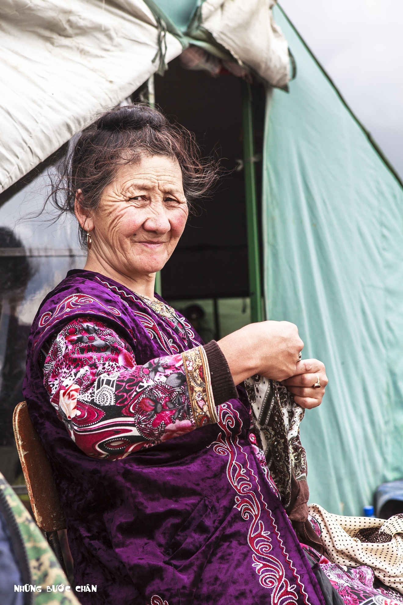 Đây là bà cụ 68 tuổi người người Kyrgyz mặc trang phục truyền thống đang chỉnh sửa lại chiếc khăn trùm đầu của mình. Phụ nữ theo đạo Hồi thường không để cho người ngoài nhìn thấy tóc nhưng một số quy định nghiêm ngặt ở một số nước Trung Đông. Tuy nhiên, ở đây họ xem tôn giáo như là một nét văn hóa hơn là nghi thức cần phải được tuân thủ.