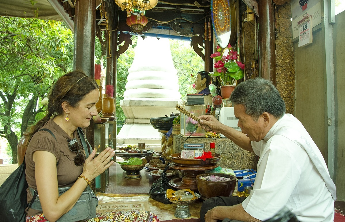 Cảnh thầy cúng đang làm phép ban phước cho khách du lịch ở Wat Phnom.