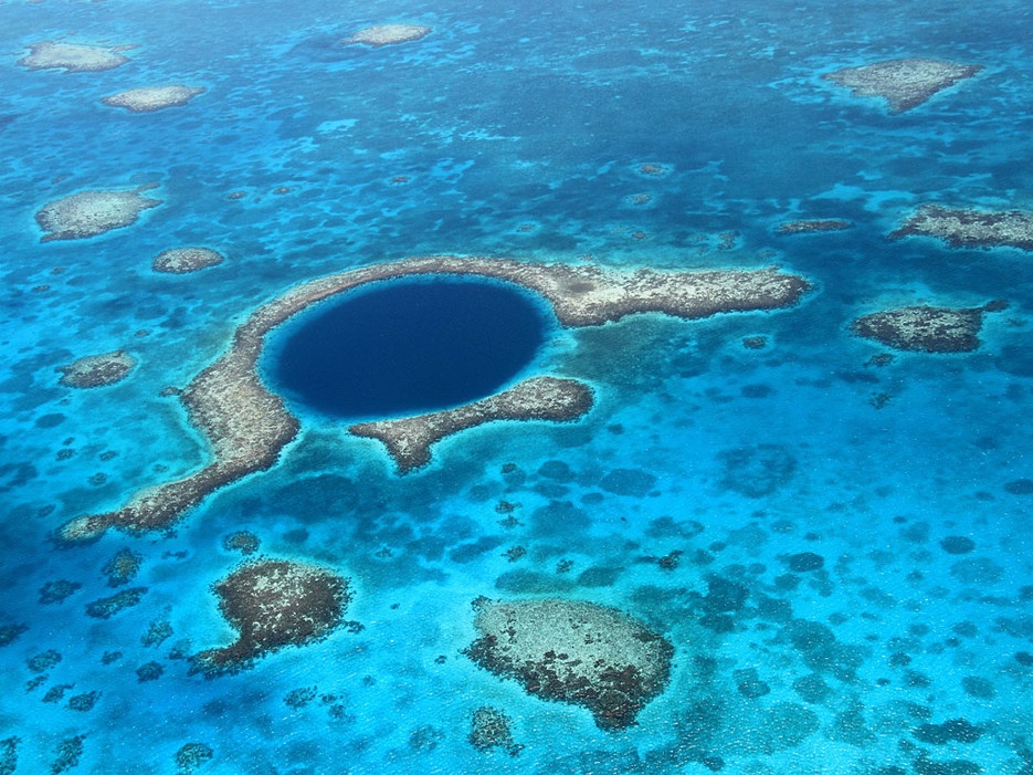 Hố xanh khổng lồ (Belize): Là một trong những hố đại dương rộng nhất thế giới, Great Blue Hole rộng gần 304 m, sâu 122 m. Hố có vách đá ngầm phát sáng nhờ cát và san hô, trong khi nước màu xanh thẫm.
