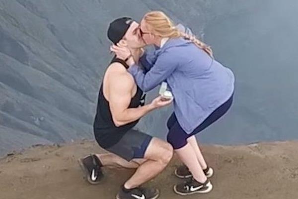 Chang trai cau hon ban gai ngot ngao tren mieng nui lua hinh anh