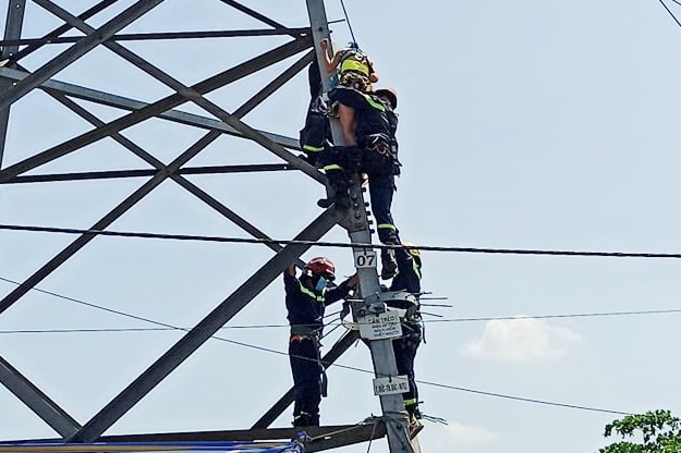 Canh sat giai cuu nguoi phu nu leo cot dien cao the hinh anh