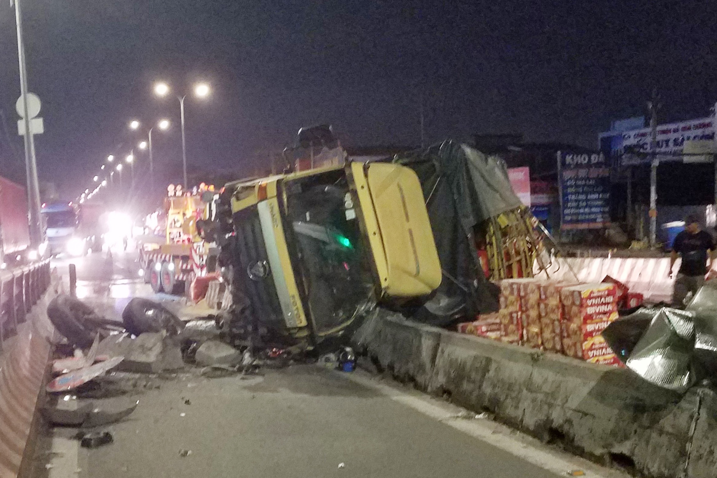 Xe tai lat tren quoc lo 1, hang chuc thung bia tran xuong duong hinh anh