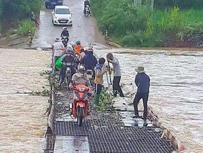 Be trai 8 tuoi bi nuoc cuon khi qua cau tam hinh anh