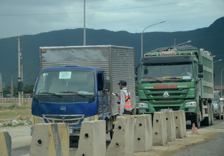Một nhân viên an ninh tại khu công nghiệp làm thủ tục kiểm tra phương tiện