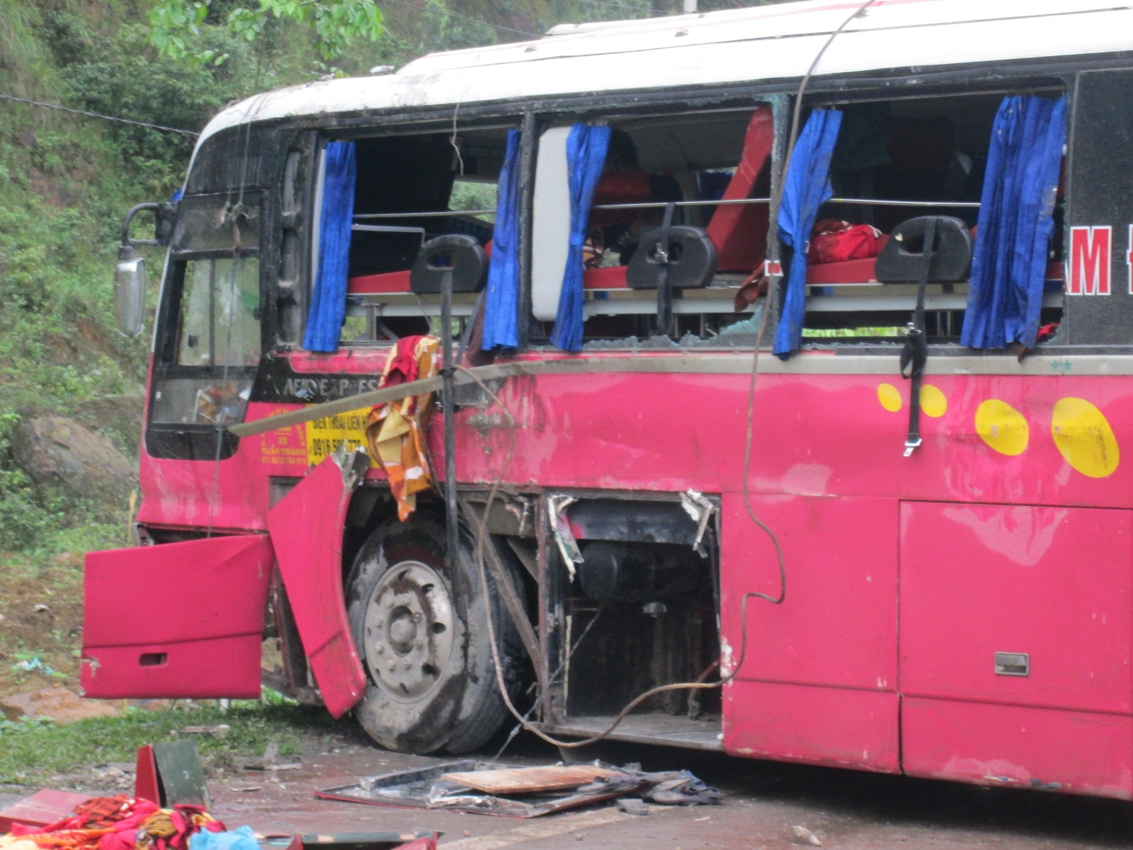 Bên trái xe cày một đường dài trên mặt đường khiến cửa kính bên hông vỡ hết.