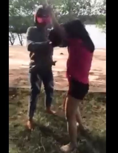 Nữ sinh bị bạn dùng mũ bảo hiểm đánh tới tấp vào đầu, vào mặt. Ảnh: Cắt từ clip.