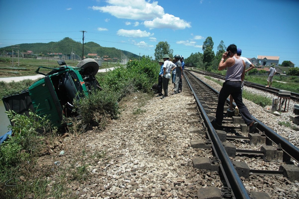 e tải bị kéo lê khoảng 50 m rồi lật nghiêng bên cạnh đường sắt. Ảnh: TY.