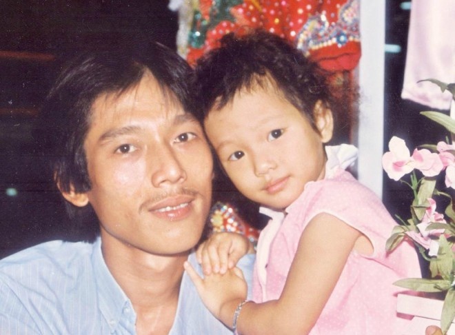 Cô con gái cưng tạo dáng rất dịu dàng cùng ba ở tiệm áo cưới của gia đình. Vy là chị cả của một em gái và một em trai.