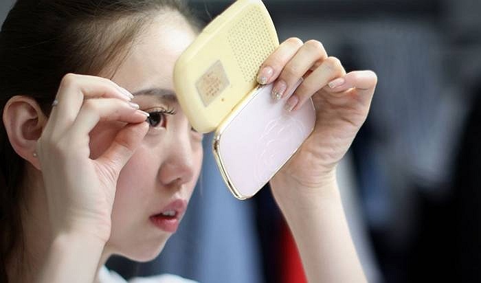 Wangwei- người mẫu xe hơi đang chuẩn bị cho một triển lãm xe ở Liêu Ninh (Trung Quốc). Cô bắt đầu công việc này từ ngày Trung học. Cô nói: Nghề này không chỉ cần khuôn mặt đẹp mà phải có sự nỗ lực.