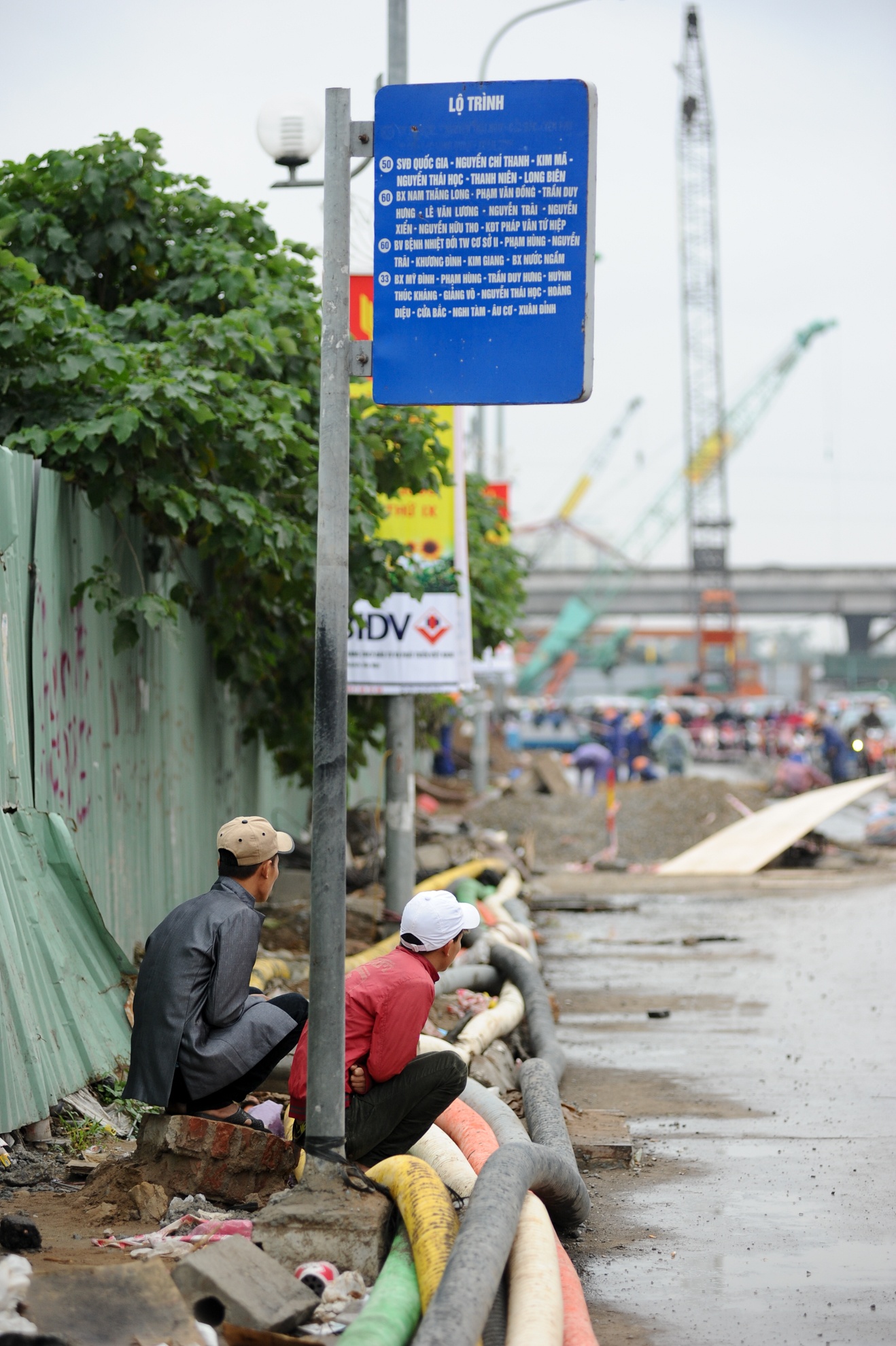 Không chỉ có người đi xe máy mà người đi buýt cũng bị “khổ lây”. Trước đây, tại đường Trần Duy Hưng có hai nhà chờ có mái che. Nhưng nay, người chờ xe buýt phải ngồi trên đống gạch đá lổn nhổn.