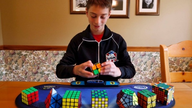 Cau be 14 tuoi lap ky luc xoay rubik trong... 4,9 giay hinh anh