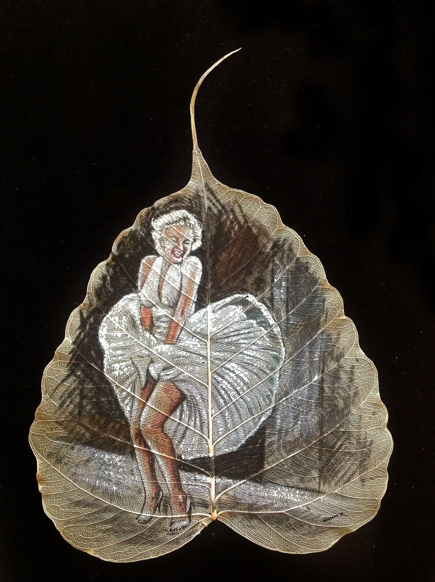 chang trai ve tranh tren la cay anh 1