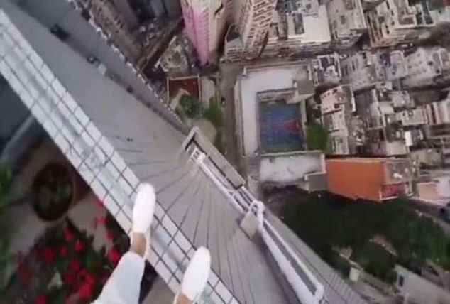 Chang trai di bo tren mep tuong nha cao tang hinh anh