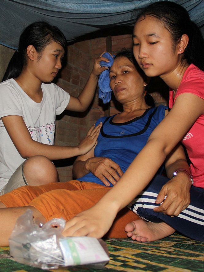 Hai chị em Linh (trái) và Trinh đang chăm sóc mẹ - Ảnh: Trần Mai