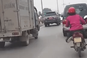 Nguoi phu nu vat cheo chan, lang lach khi di xe may tren pho hinh anh