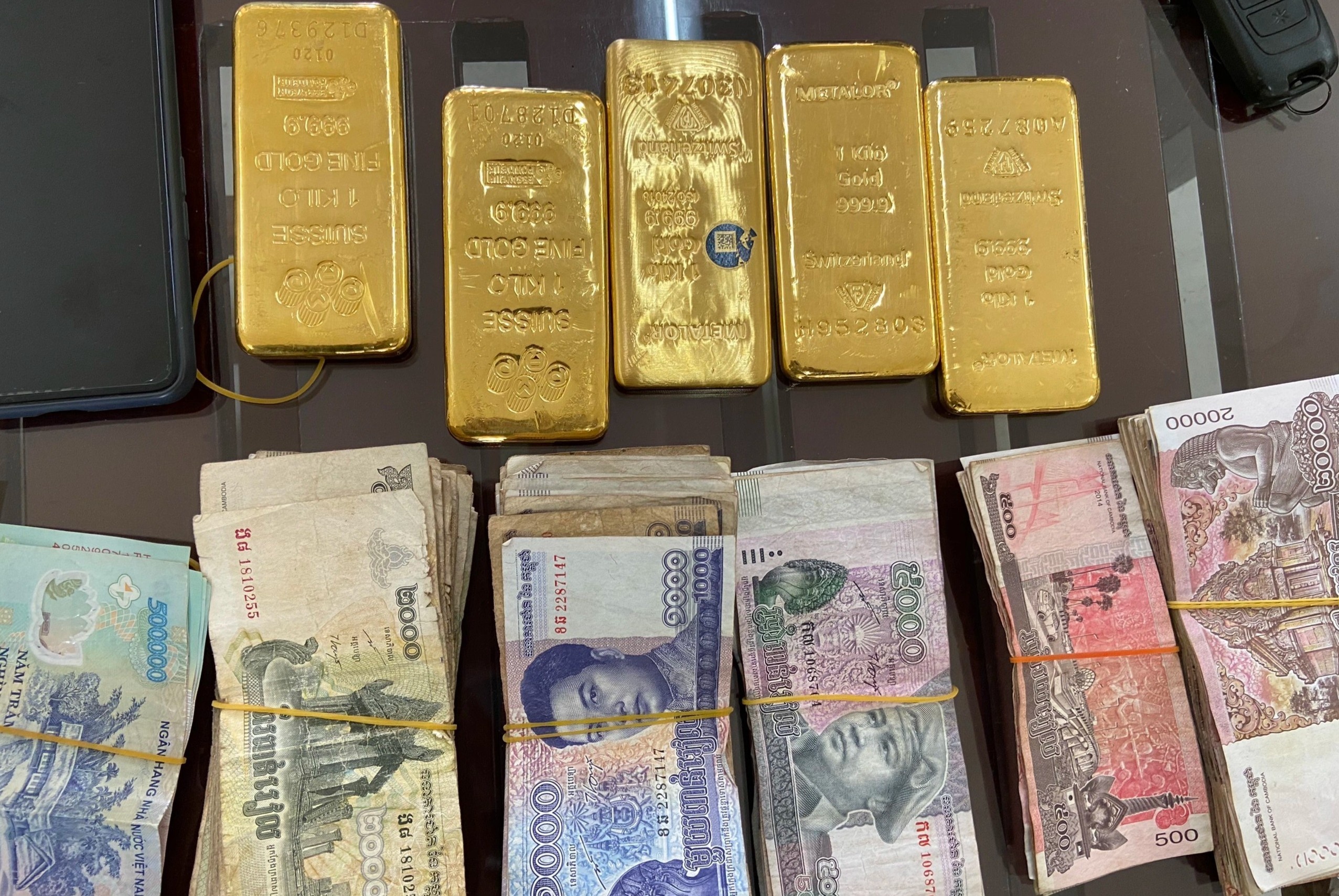 Nguoi phu nu van chuyen 5 kg vang va tien ngoai te hinh anh