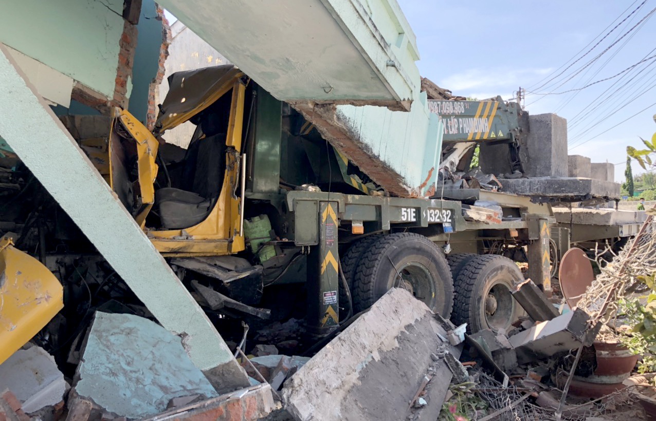 Xe cau tong sap 2 nha dan,  tai xe bi thuong nang anh 1