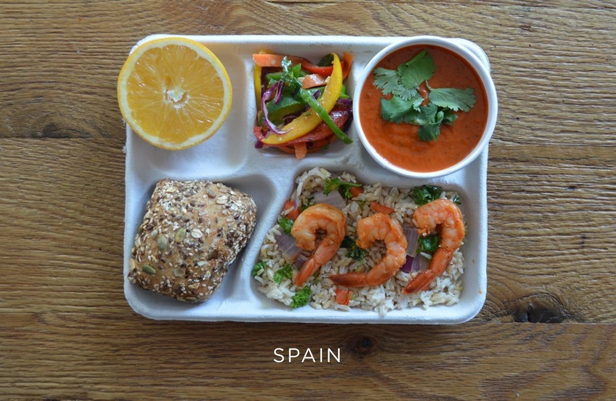 Spain: sautéed shrimp, brown rice, veggies, gazpacho, fresh peppers, bread, orange