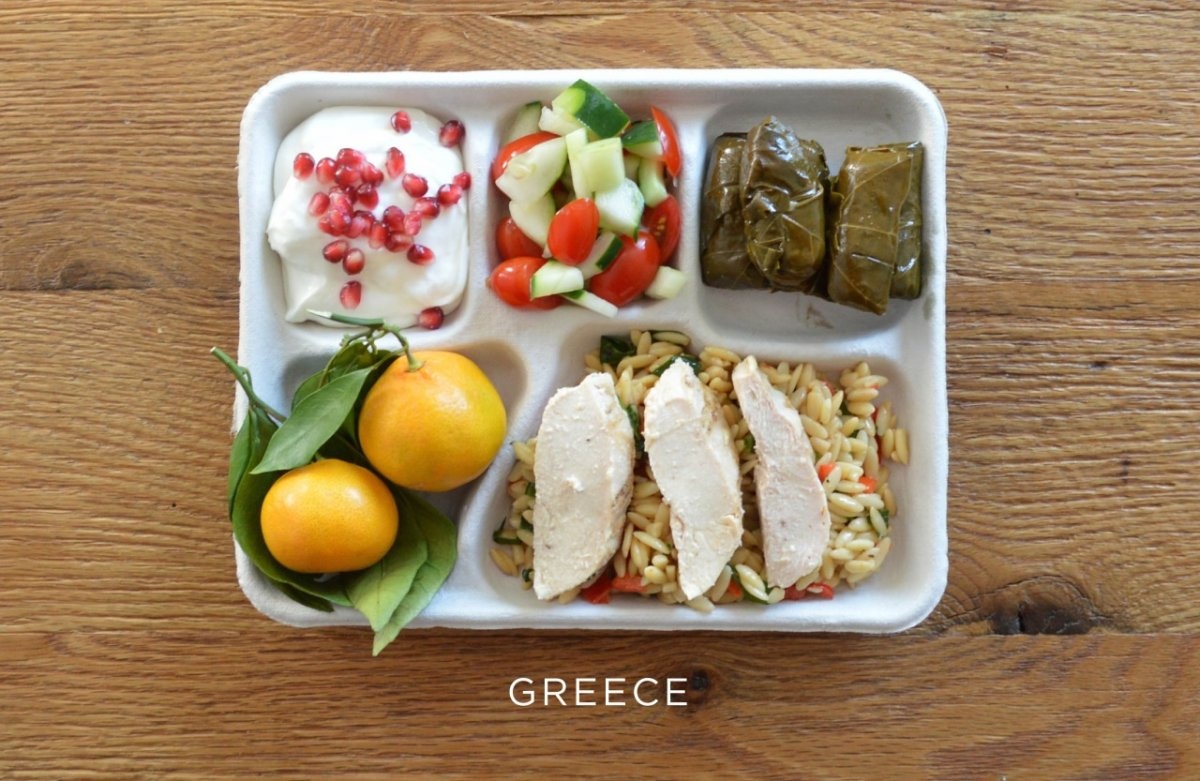 Greece: baked chicken over orzo, stuffed grape leaves, tomato-and-cucumber salad, fresh oranges, yogurt with pomegranate seeds
